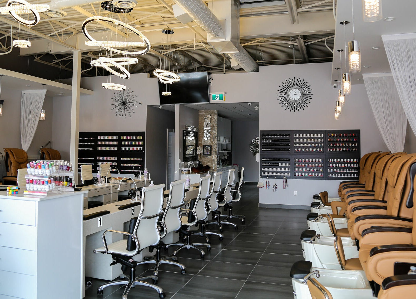 Elegant interior of LTN Nails & Spa in Langley City, British Columbia, CA showcasing chairs and nail polish displays.