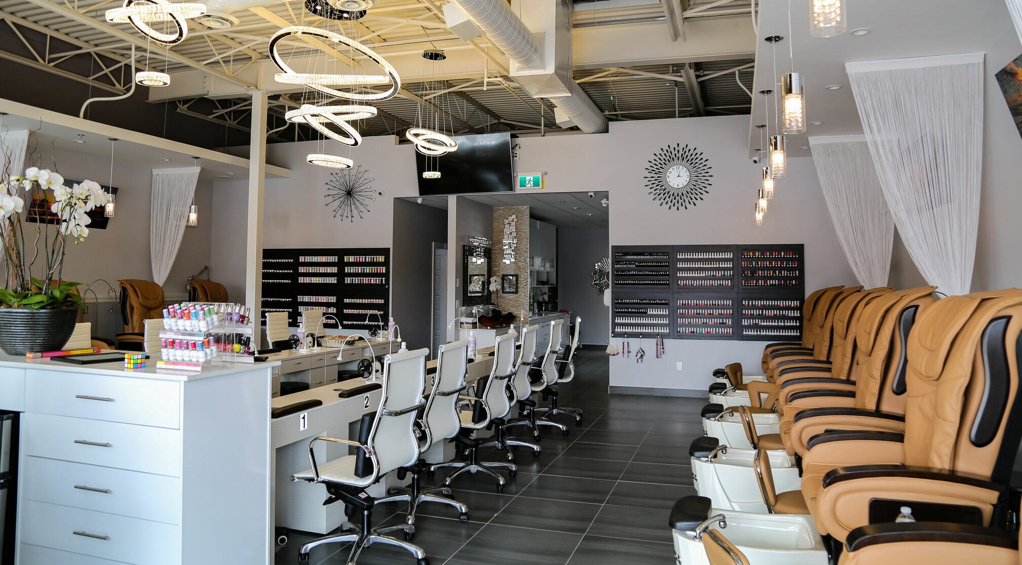 Elegant interior of LTN Nails & Spa in Langley City, British Columbia, CA showcasing chairs and nail polish displays.