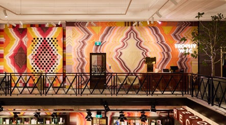 Bright, colorful interior of Trophy Wife Nails | Mecca Bourke St CBD in Melbourne, Victoria, AU with geometric wall art.