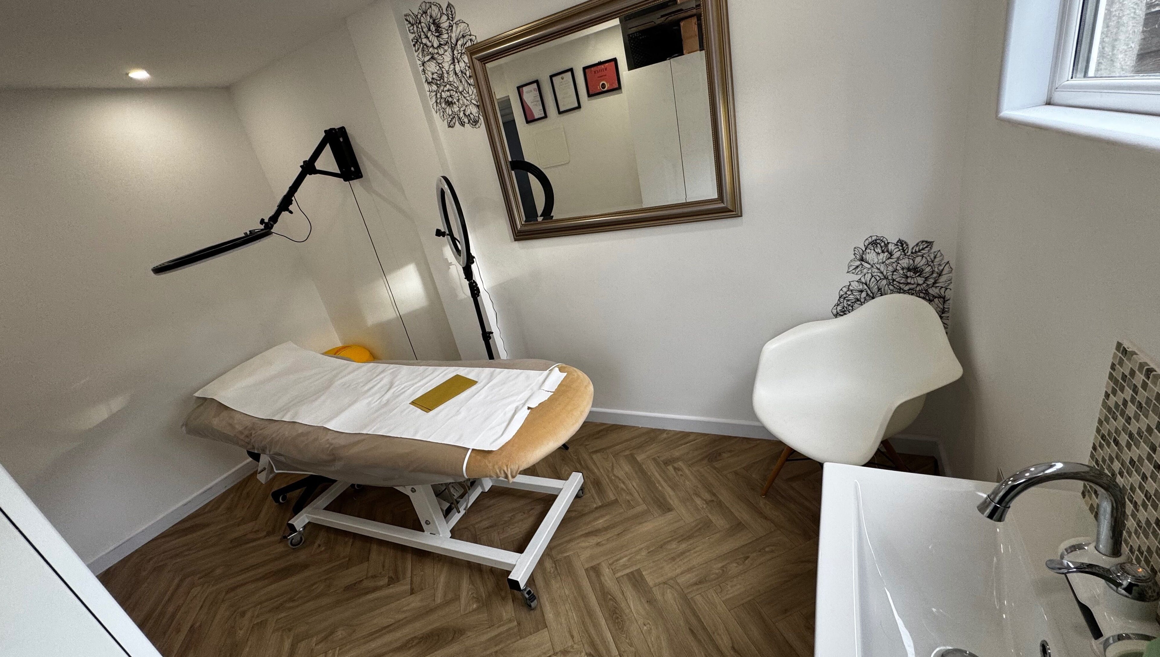 Tranquil treatment room at Revida Aesthetics, Broadstairs, England, GB, featuring a comfortable bed and modern decor.