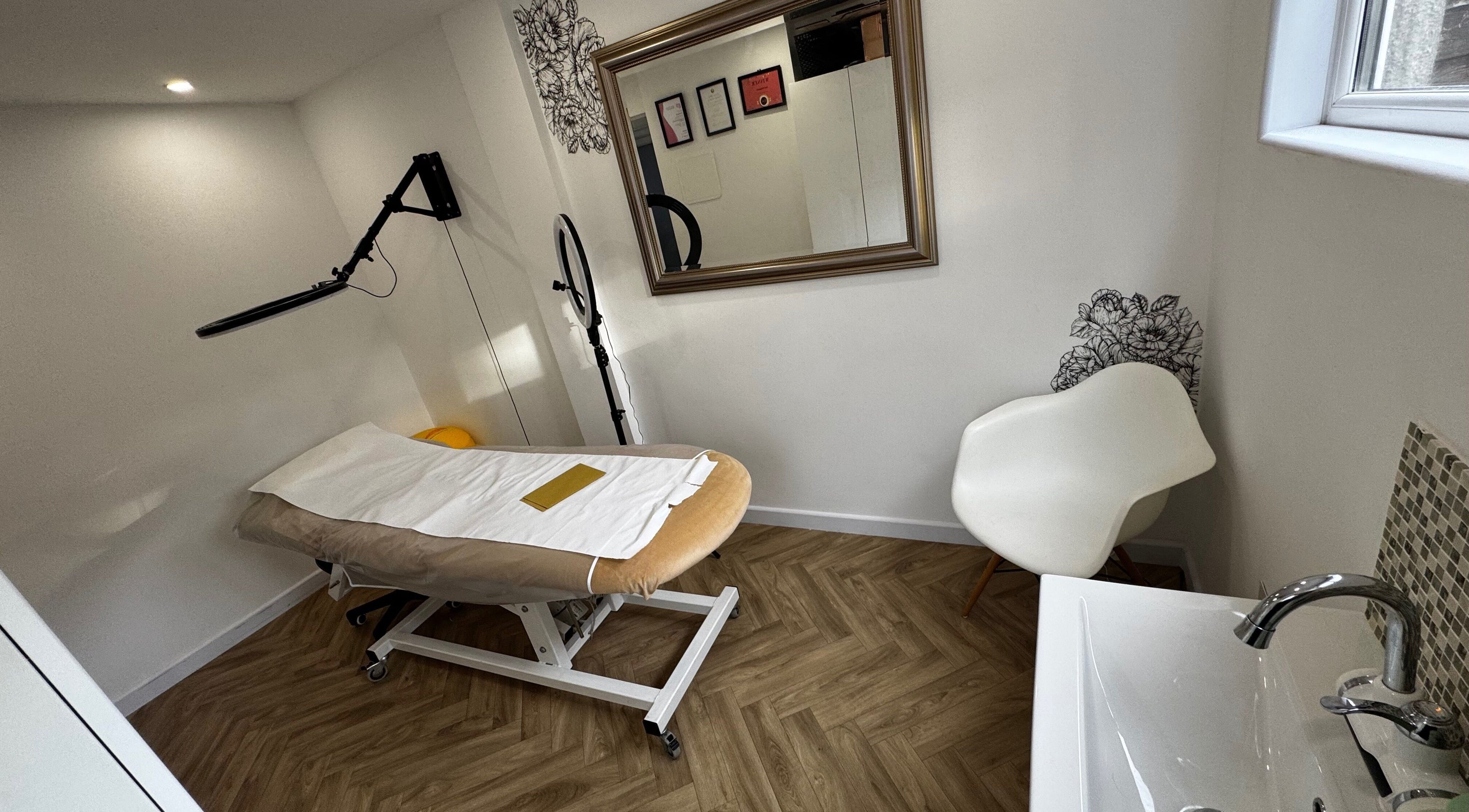 Tranquil treatment room at Revida Aesthetics, Broadstairs, England, GB, featuring a comfortable bed and modern decor.