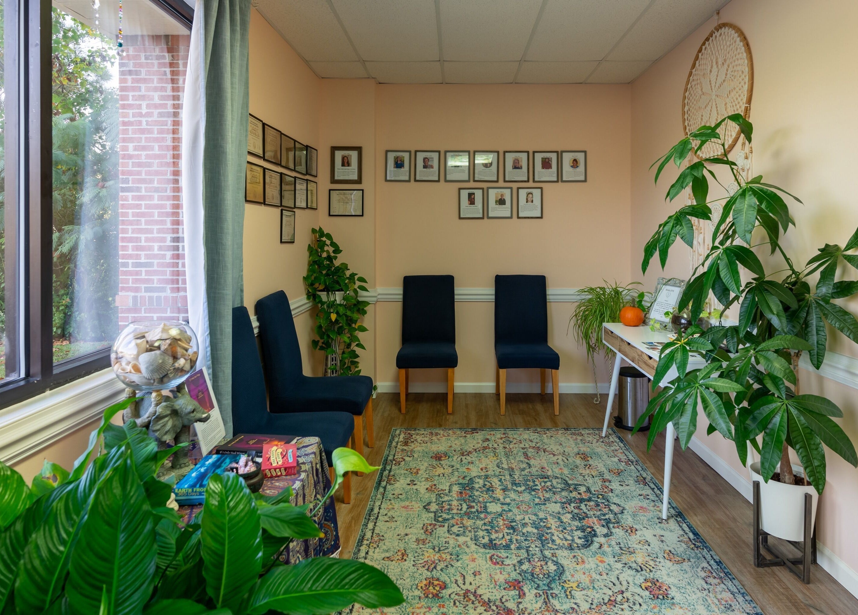 Inviting waiting area at Healing Hippie in Hampstead, North Carolina, US with cozy seating and indoor plants.