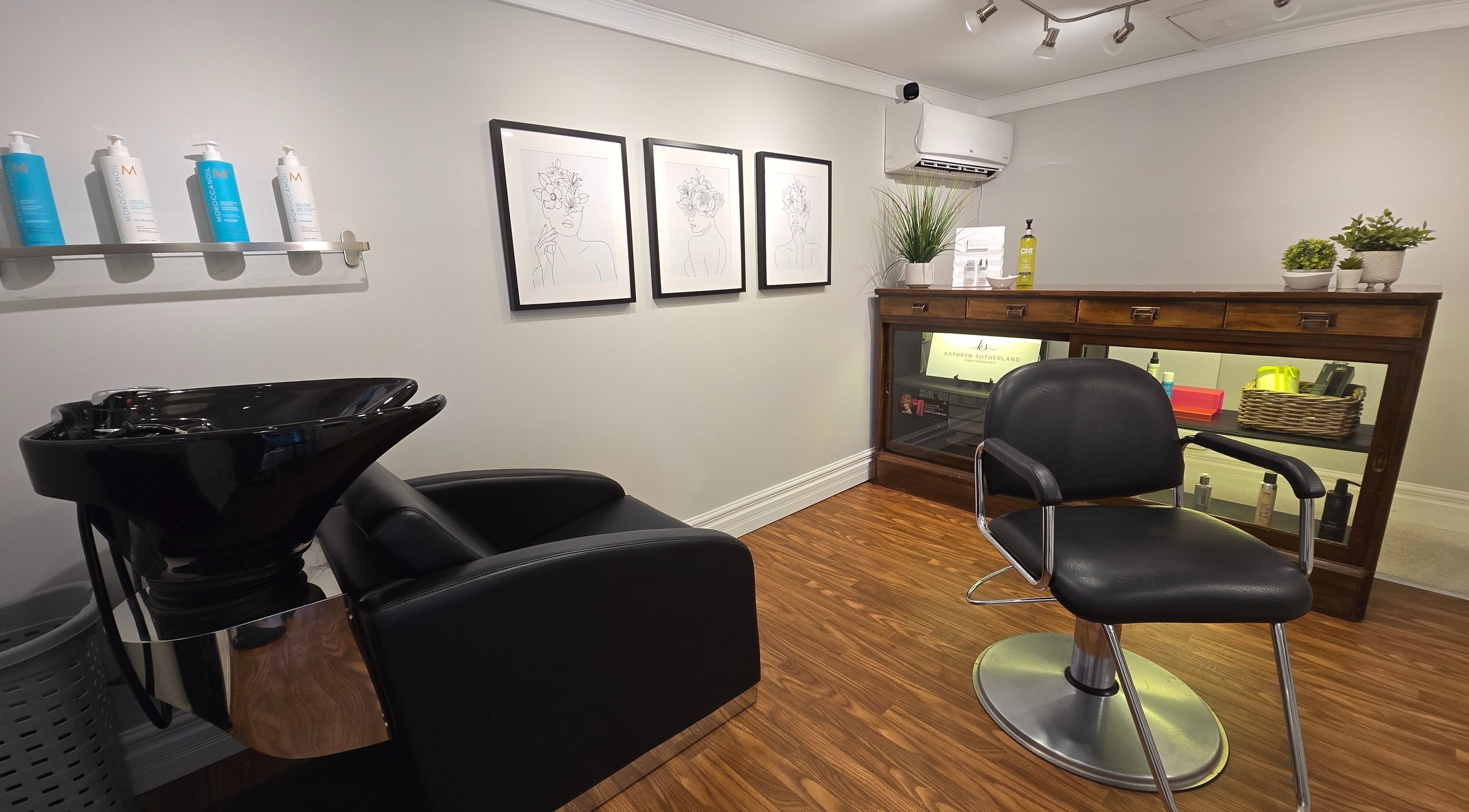 Modern hair salon interior at Kathryn Sutherland Hairstyling, Saint Clements, Ontario, CA, showcasing elegance and style.