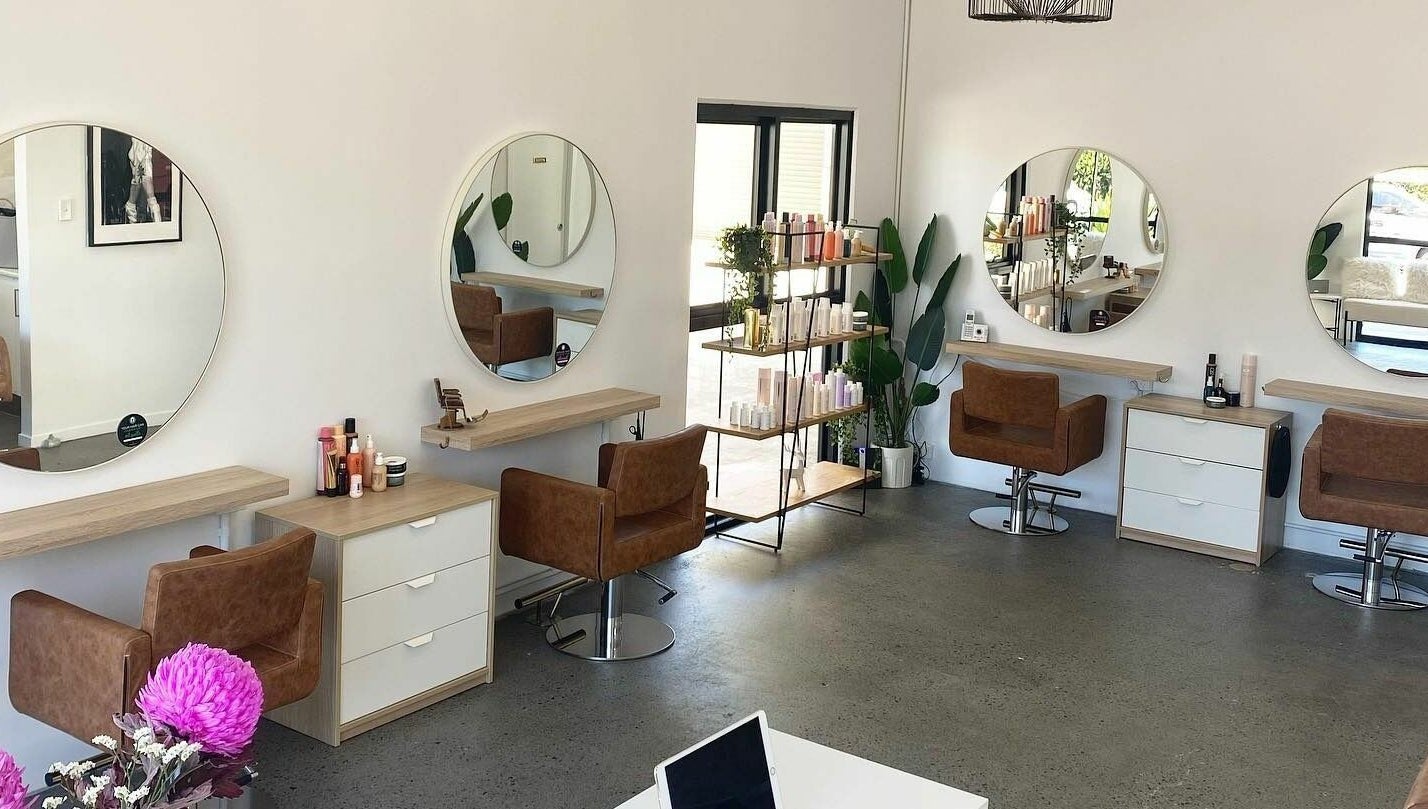 Modern salon interior at Harris and Co., Burleigh Heads, Queensland, AU, featuring elegant styling stations.