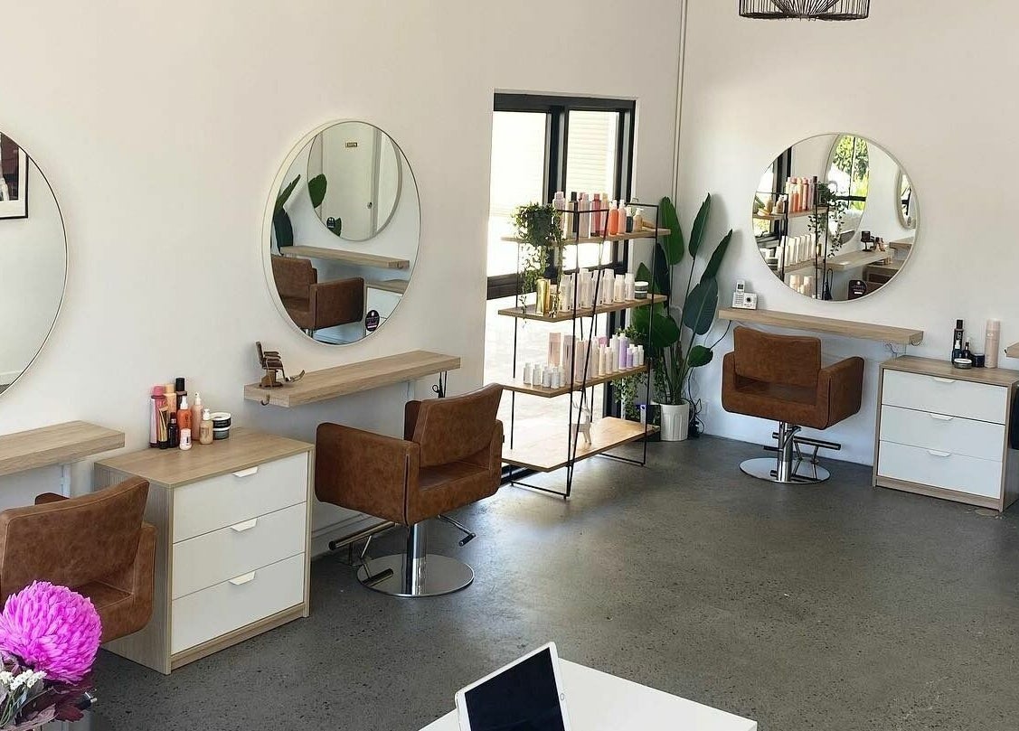 Modern salon interior at Harris and Co., Burleigh Heads, Queensland, AU, featuring elegant styling stations.