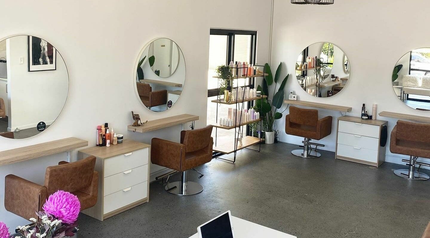 Modern salon interior at Harris and Co., Burleigh Heads, Queensland, AU, featuring elegant styling stations.