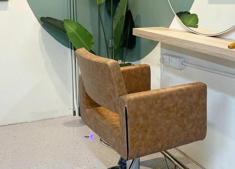 Contemporary salon chair in Harris and Co., Burleigh Heads, Queensland, AU, with a stylish mirror and plant decor.