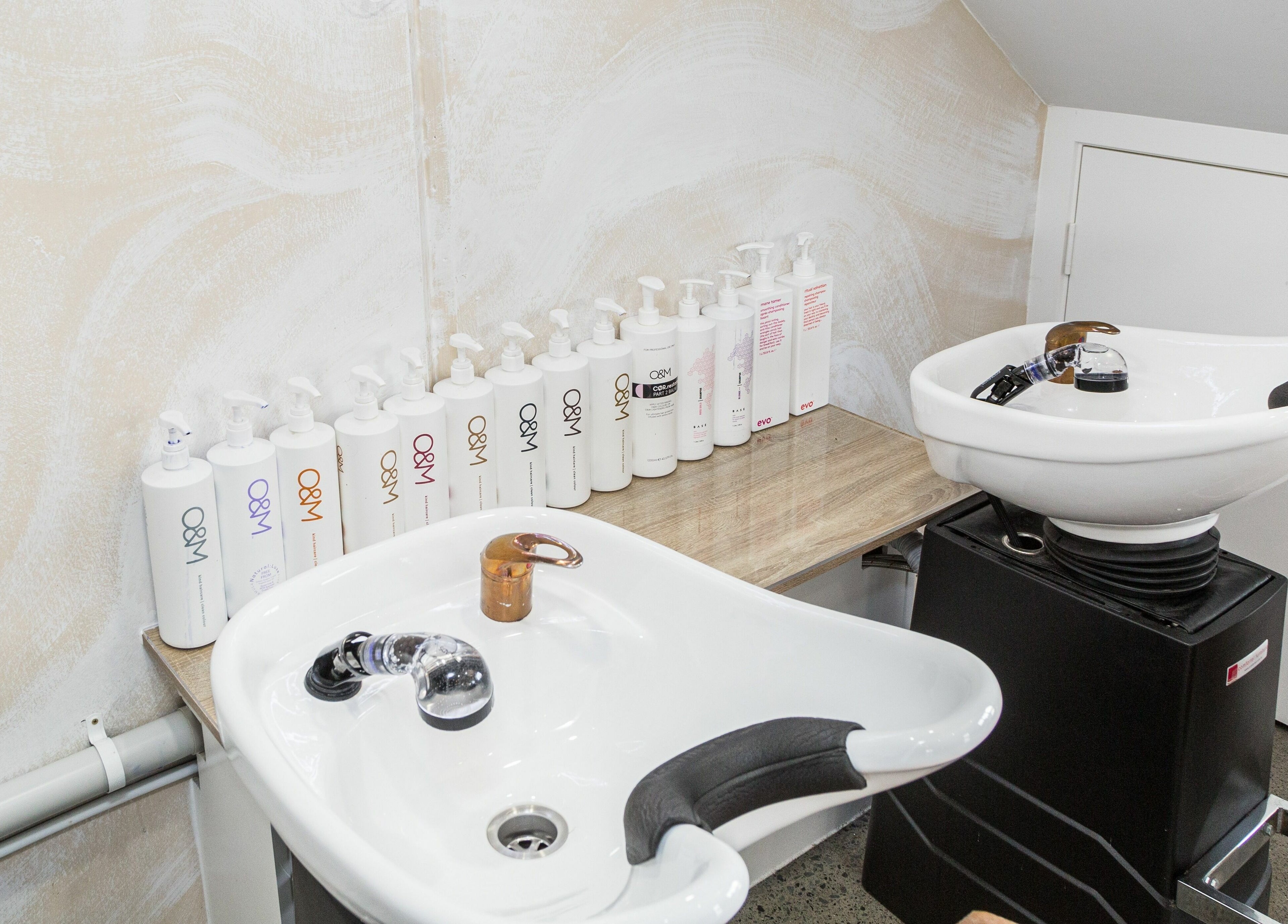 Wash stations at Harris and Co., Burleigh Heads, Queensland, AU, with premium hair care products.
