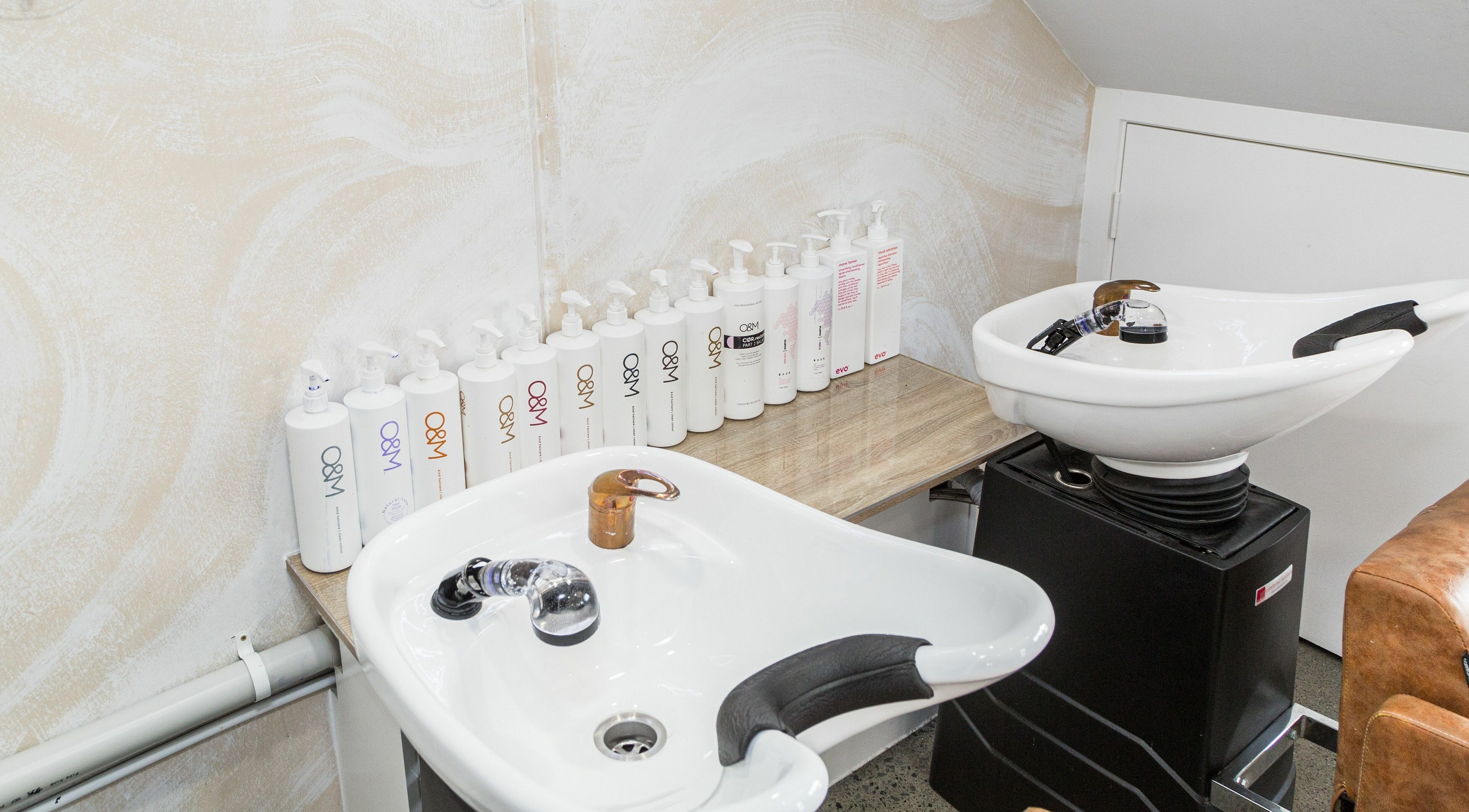Wash stations at Harris and Co., Burleigh Heads, Queensland, AU, with premium hair care products.