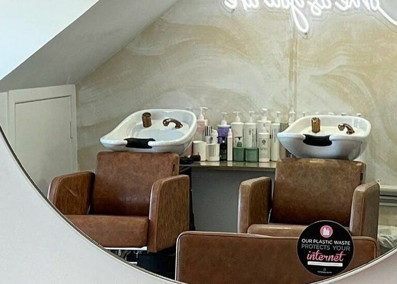 Elegant hair wash station at Harris and Co., Burleigh Heads, Queensland, AU with stylish seating and products.