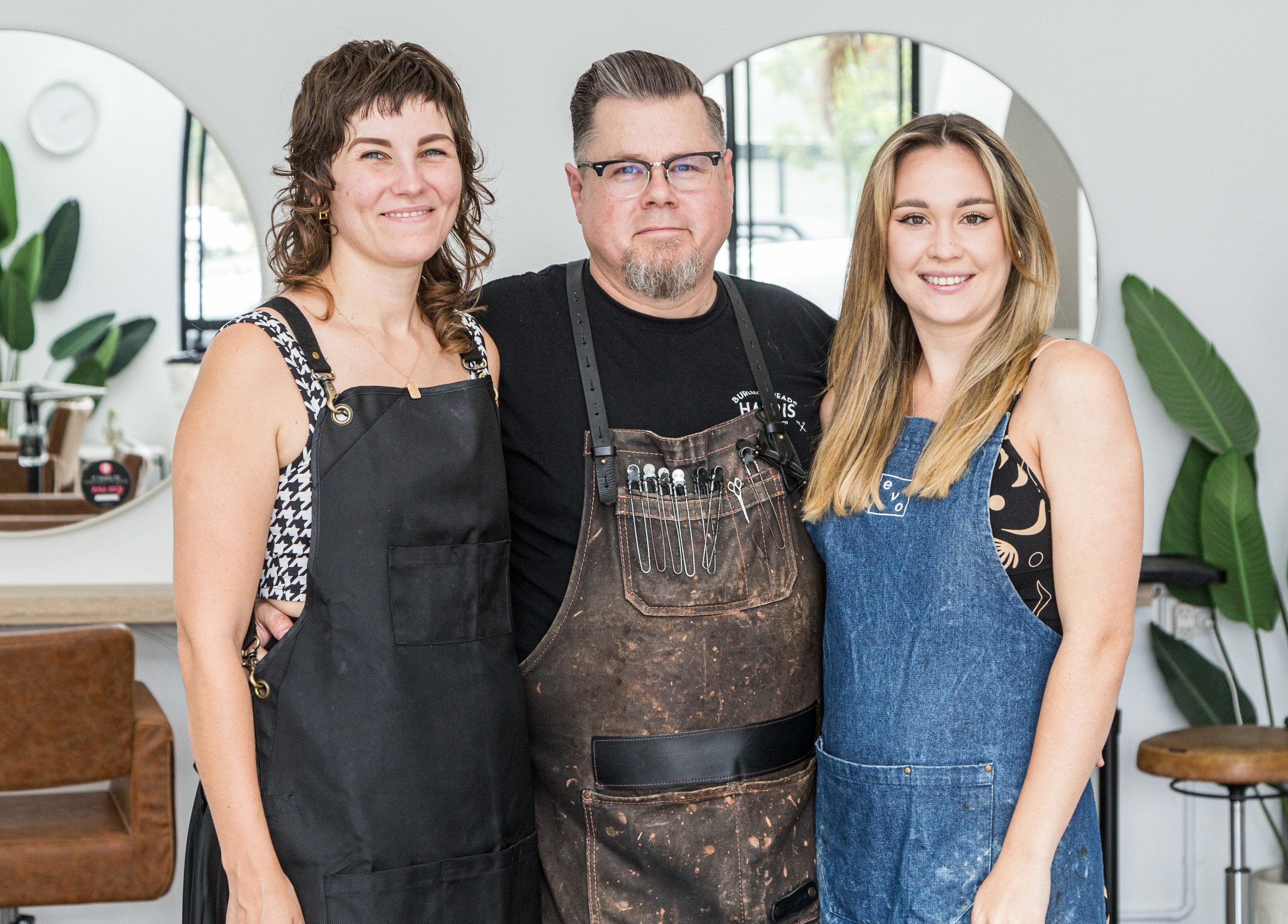 Team at Harris and Co. in Burleigh Heads, Queensland, AU standing together in the salon with smiles.