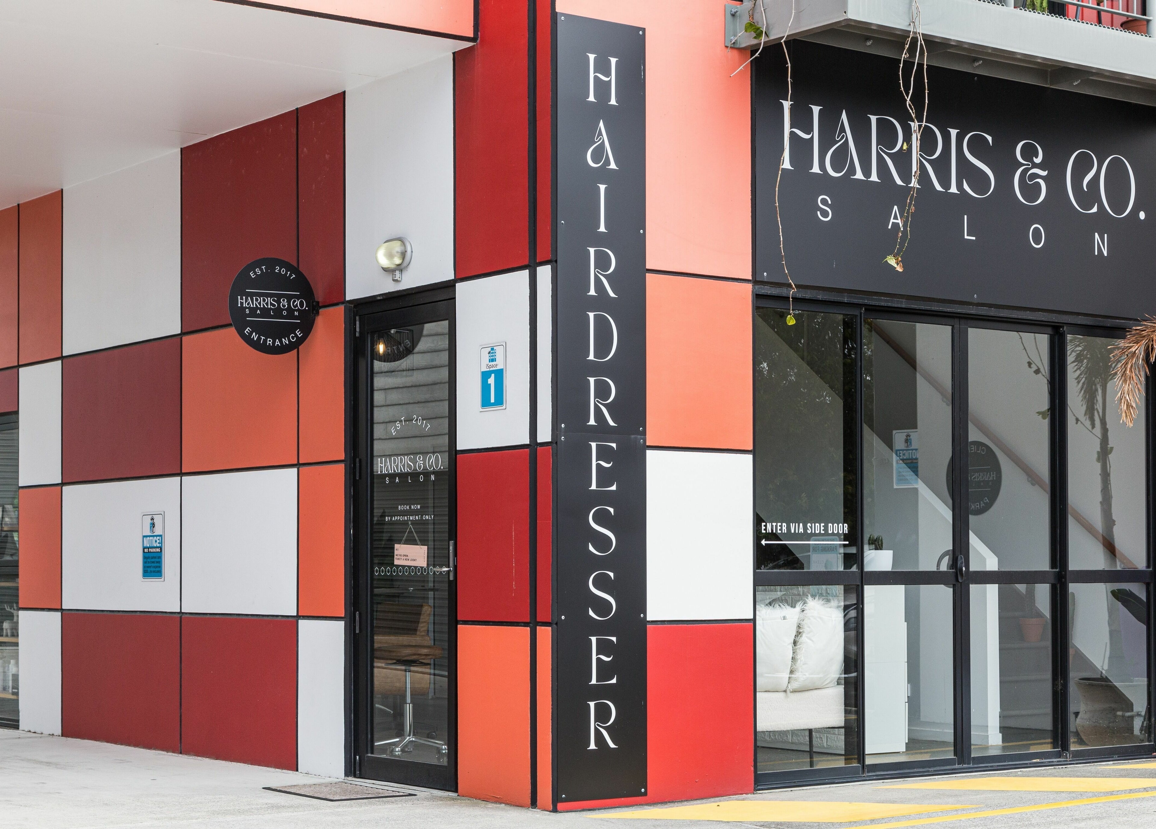 Modern exterior of Harris and Co. hairdresser in Burleigh Heads, Queensland, AU, showcasing sleek design.