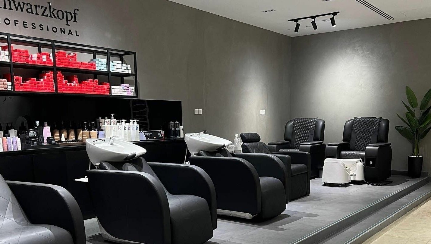 Modern salon interior at Art Lab by Bariks Salon, Dubai, Dubai, AE, featuring sleek black chairs and hair products.