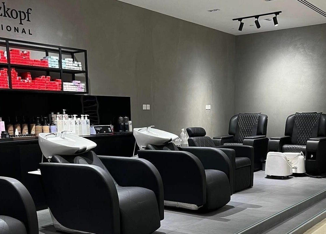 Modern salon interior at Art Lab by Bariks Salon, Dubai, Dubai, AE, featuring sleek black chairs and hair products.
