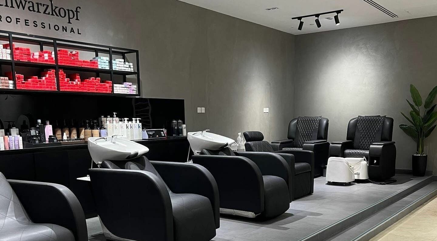 Modern salon interior at Art Lab by Bariks Salon, Dubai, Dubai, AE, featuring sleek black chairs and hair products.