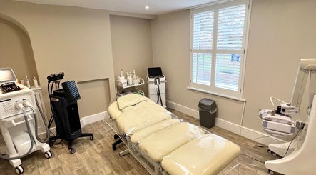 Modern treatment room at Pro Level Beauty, Malton, England, GB with spa bed and equipment.