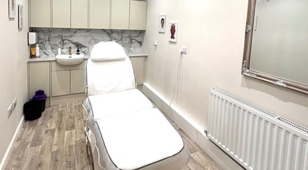 Tranquil treatment room at Pro Level Beauty, Malton, England, GB, featuring a comfortable bed and elegant decor.
