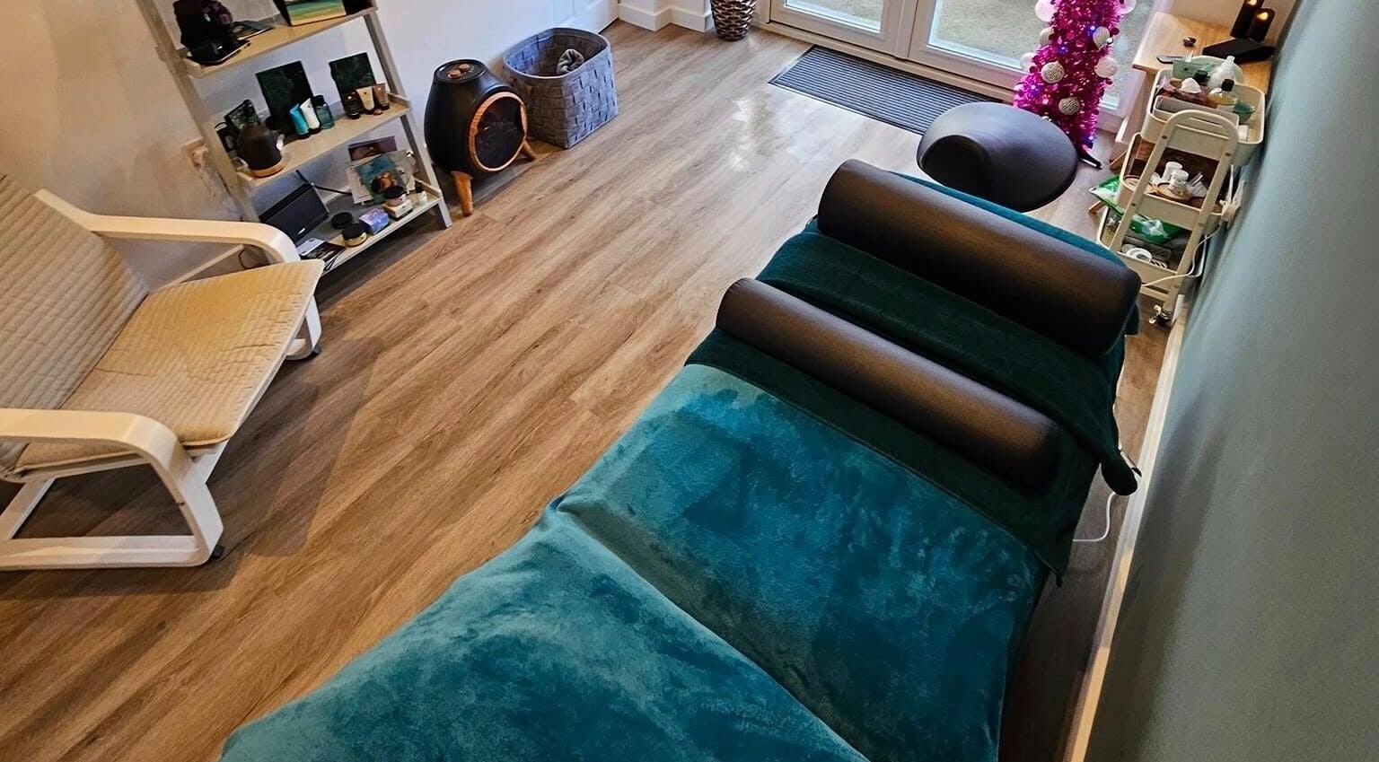 Relaxing therapy room at The Reflex Clinic, Newton Aycliffe, England, GB, featuring cozy seating and treatment bed.