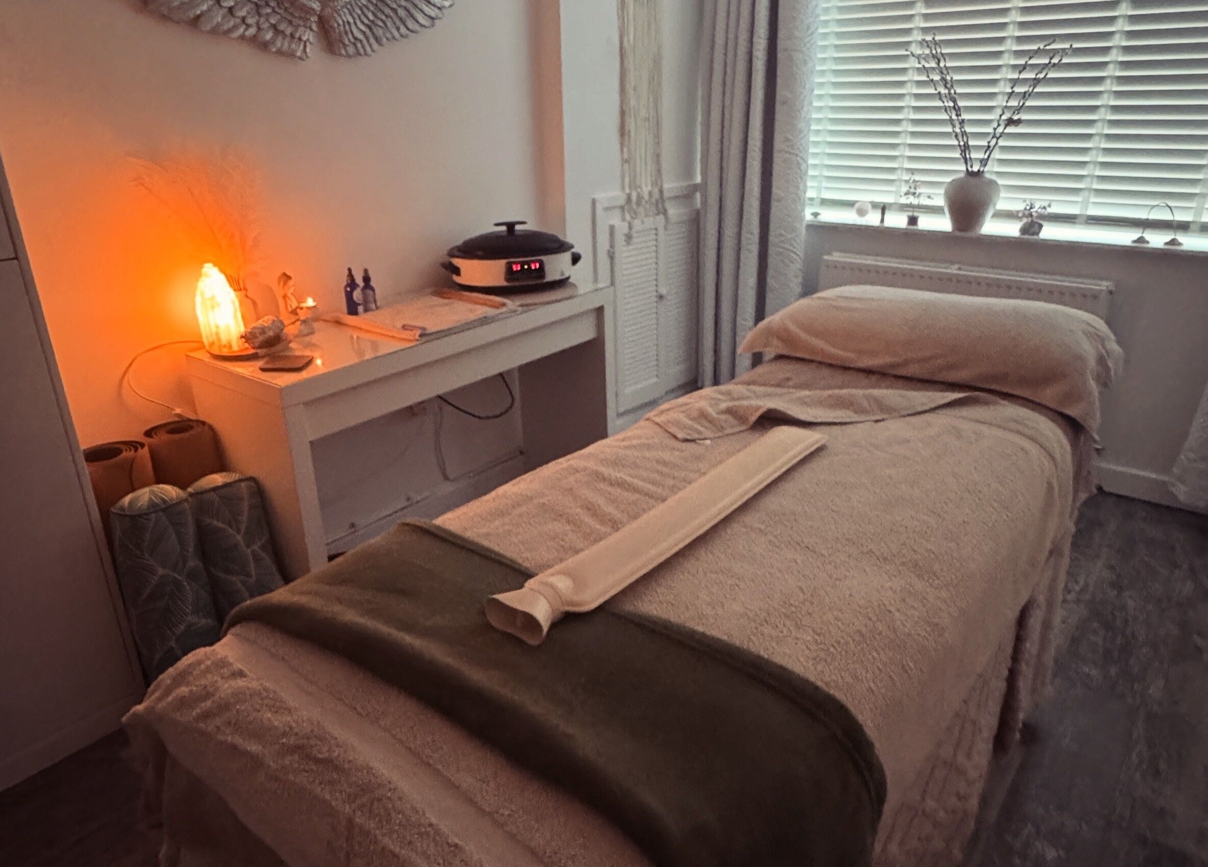Serene massage room at Clare O'Grady Holistic Therapies, Hyde, England, GB with warm lighting and cozy decor.