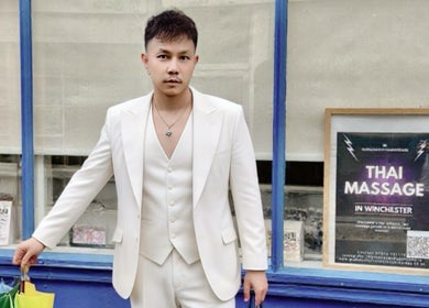 Thai male masseur outside Gussanova Thai Massage Therapy, London, England, GB.