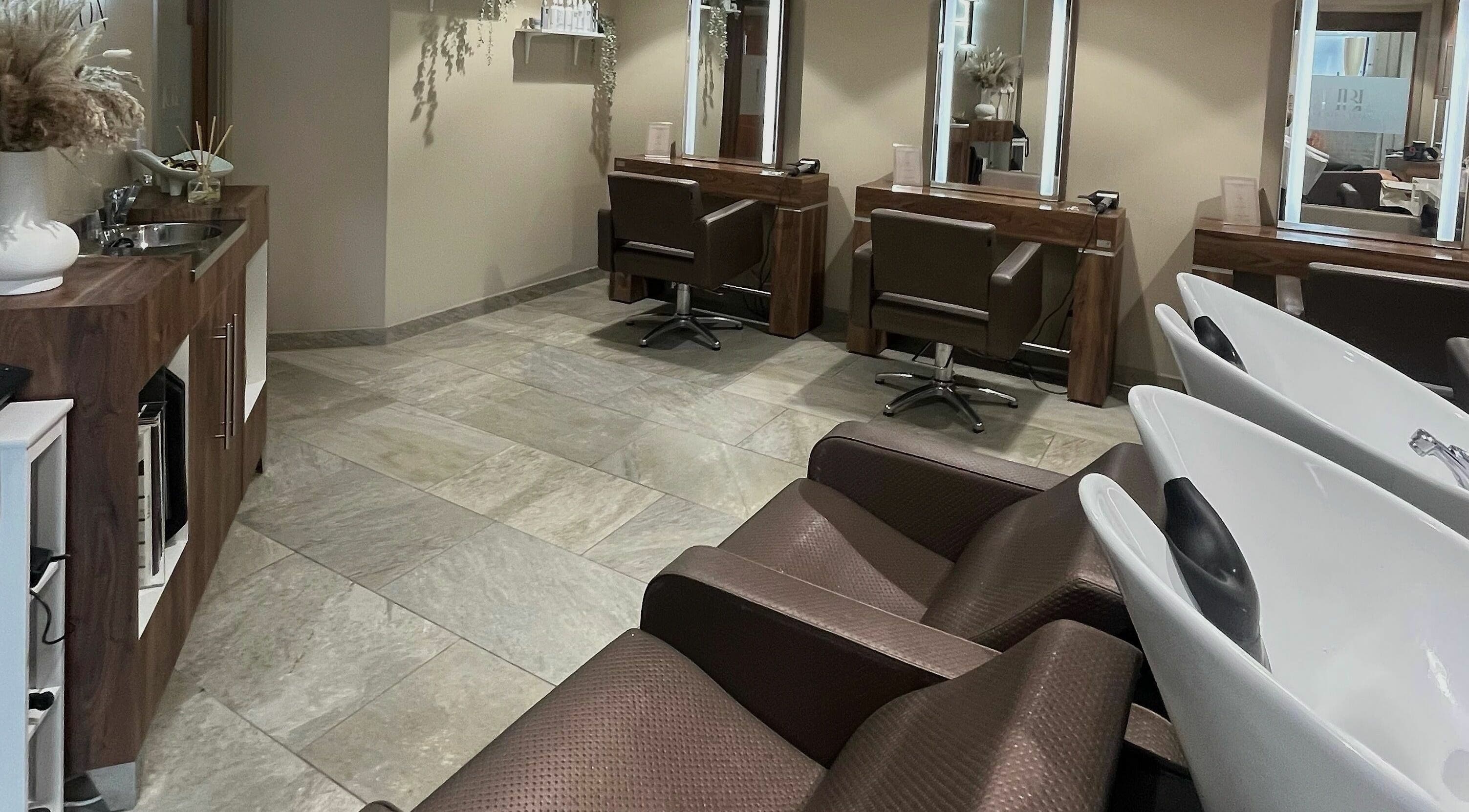 Modern styling area with chairs and mirrors at Hbl Hair Salon, Chudleigh, England, GB.