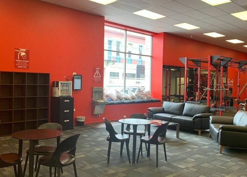 Spacious lounge and gym area at Snap Fitness Invercargill, Invercargill, Southland, NZ, featuring seating and equipment.