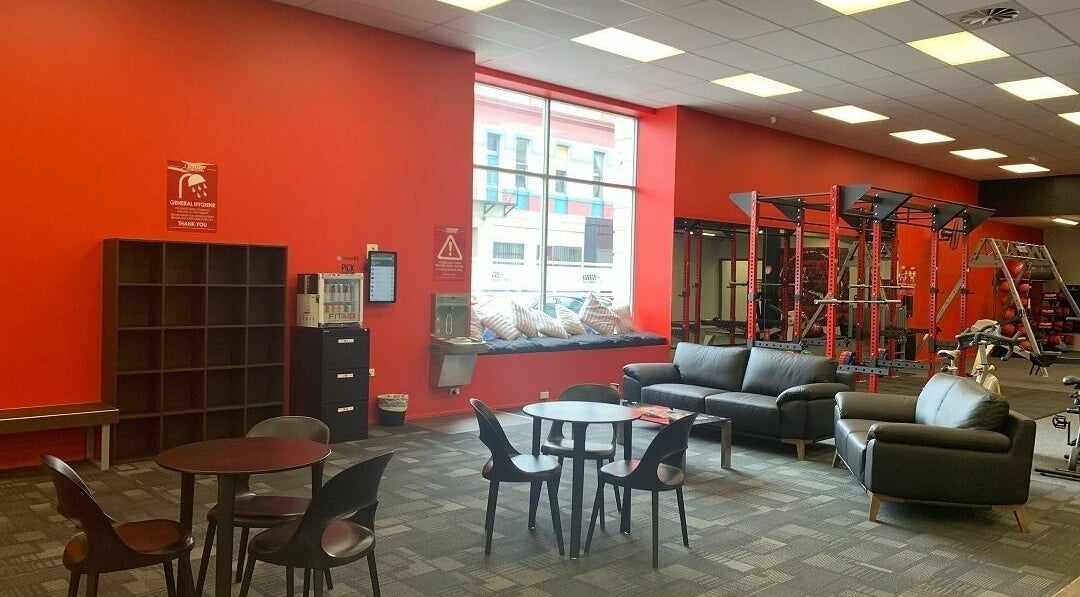 Spacious lounge and gym area at Snap Fitness Invercargill, Invercargill, Southland, NZ, featuring seating and equipment.