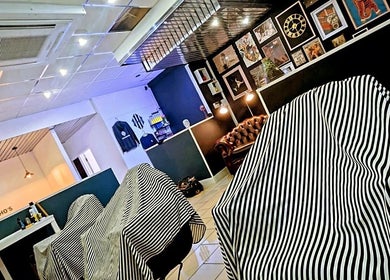 Elegant striped chairs at Head Honcho's Barbershop/Salon, Newton Abbot, England, GB.