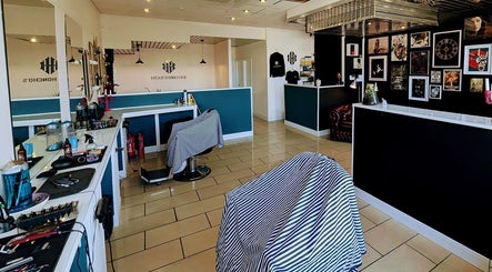 Modern interior of Head Honcho's Barbershop/Salon in Newton Abbot, England, GB with stylish decor and barber chairs.