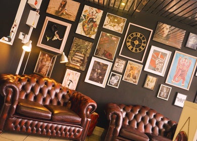 Stylish seating area at Head Honcho's Barbershop/Salon in Newton Abbot, England, GB, featuring unique wall art.