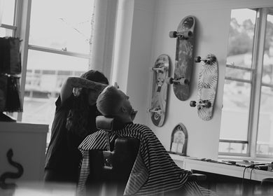 Inside Head Honcho's Barbershop/Salon, Newton Abbot, England, showcasing a modern barber session with skateboards.