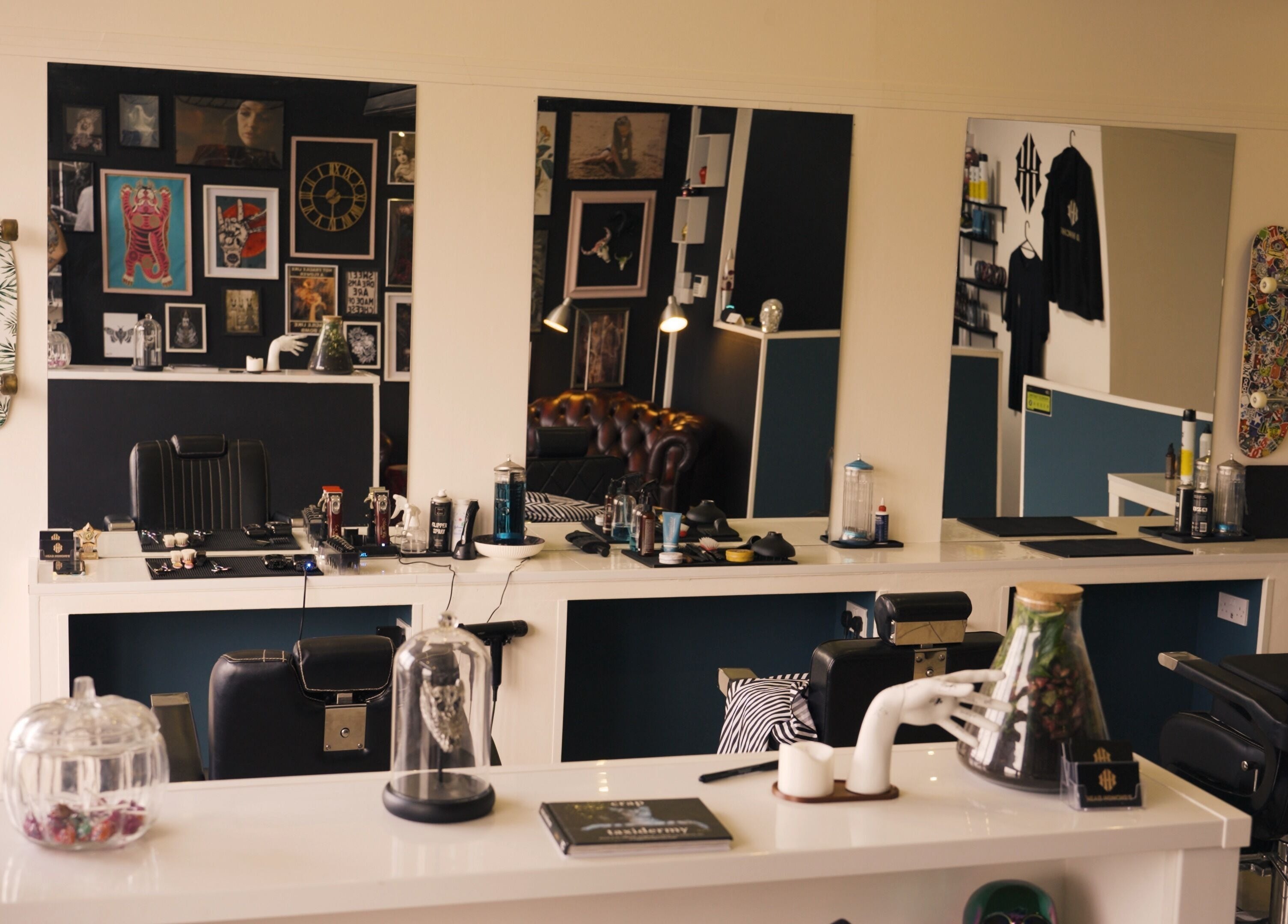 Modern interior of Head Honcho's Barbershop/Salon in Newton Abbot, England, GB with chic decor and styling chairs.