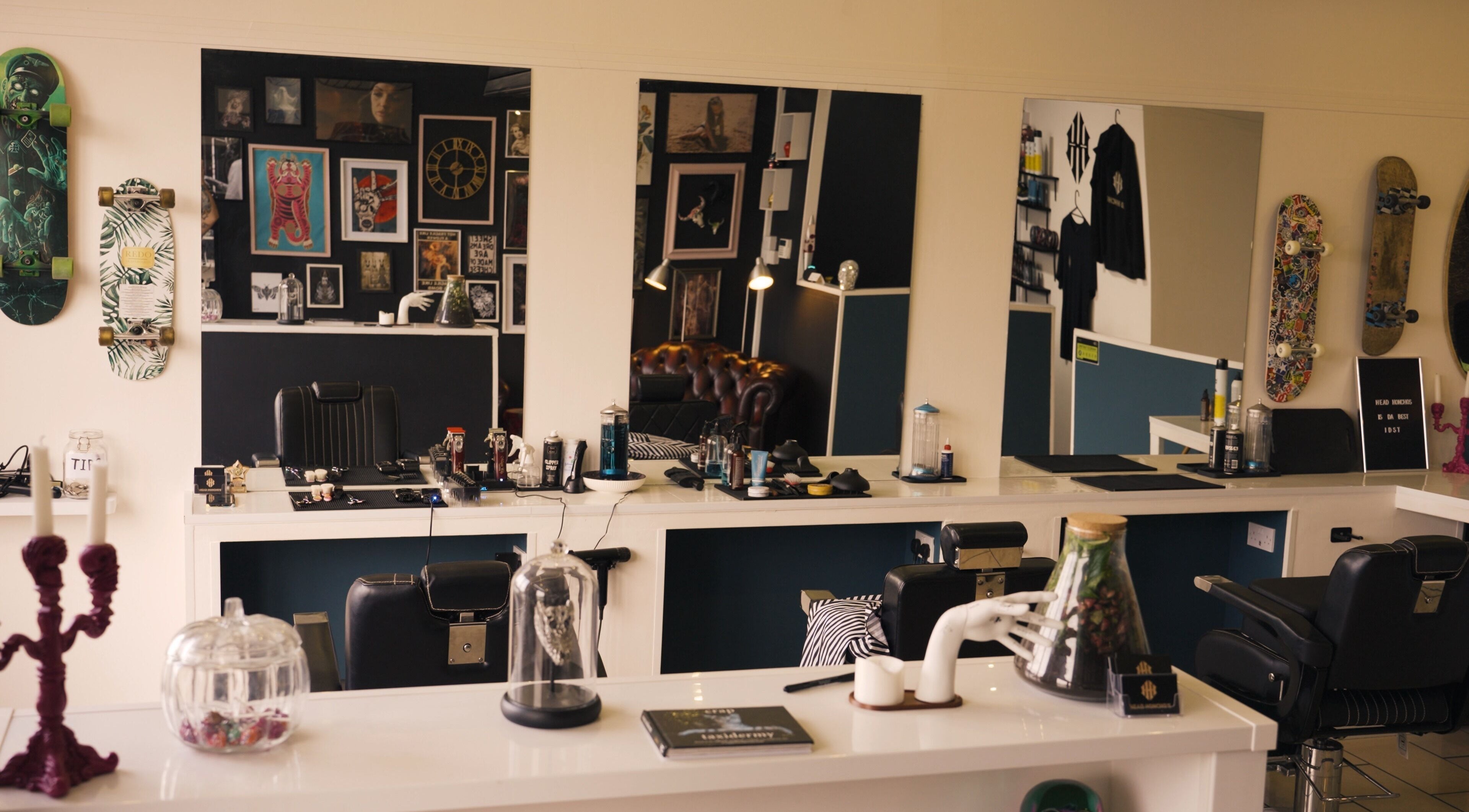 Modern interior of Head Honcho's Barbershop/Salon in Newton Abbot, England, GB with chic decor and styling chairs.