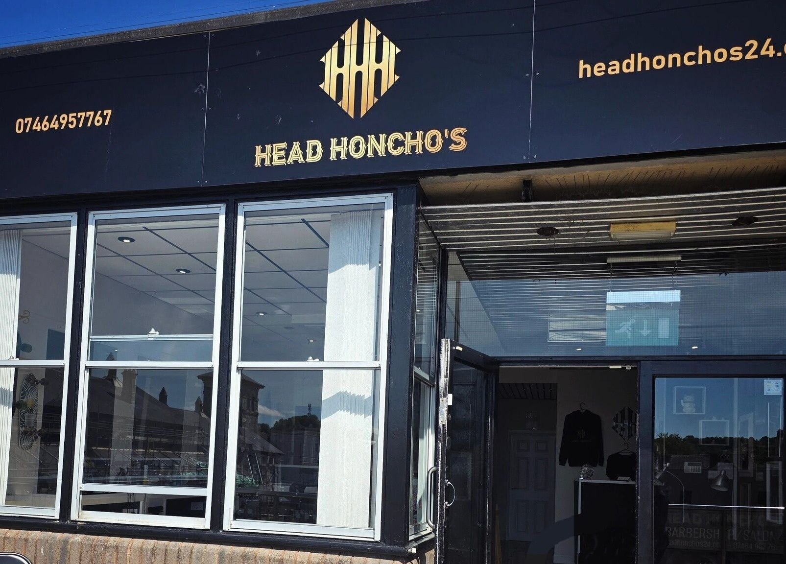 Front view of Head Honcho's Barbershop/Salon, Newton Abbot, England, showcasing modern exterior design.