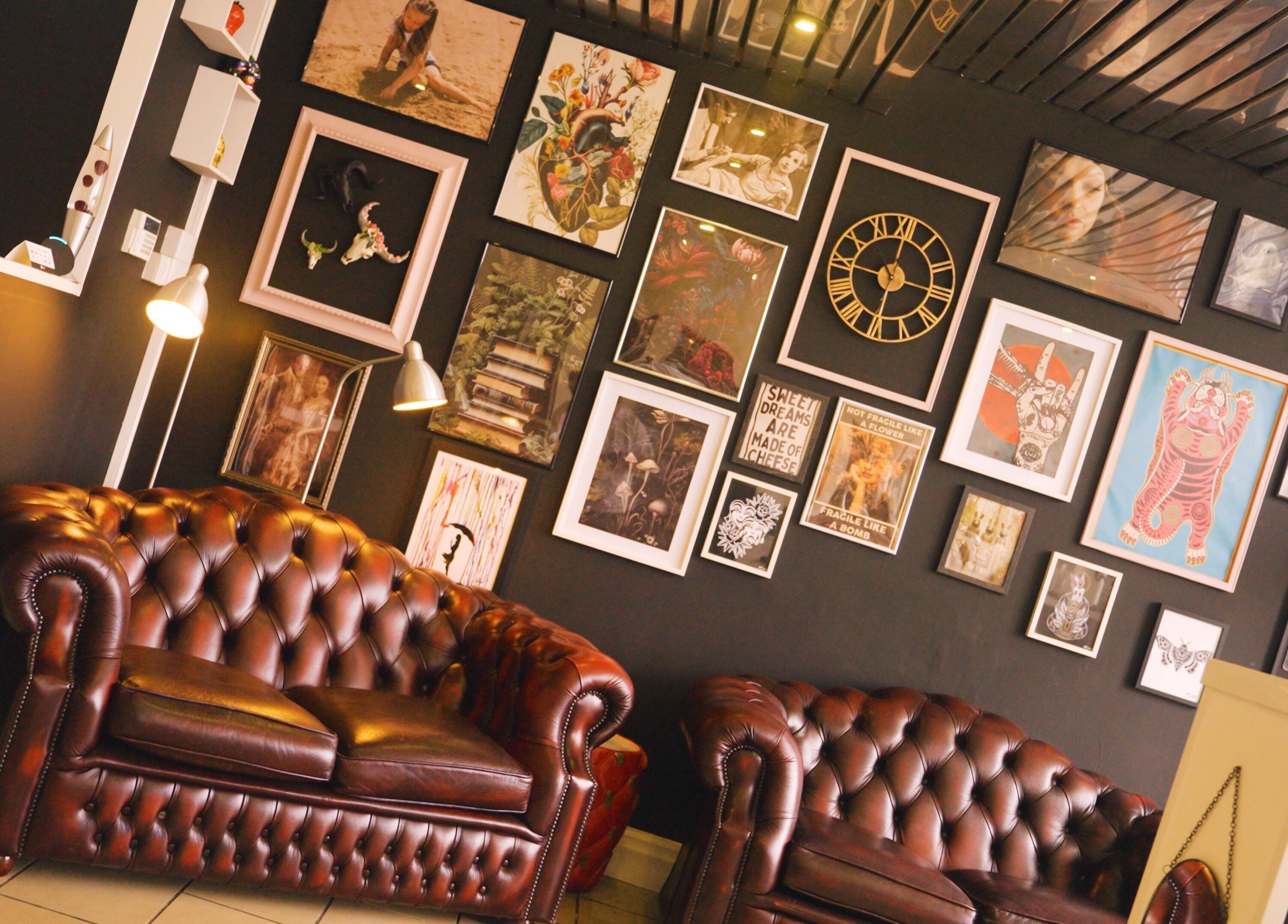 Cozy lounge at Head Honcho's Barbershop/Salon in Newton Abbot, England with artistic decor.