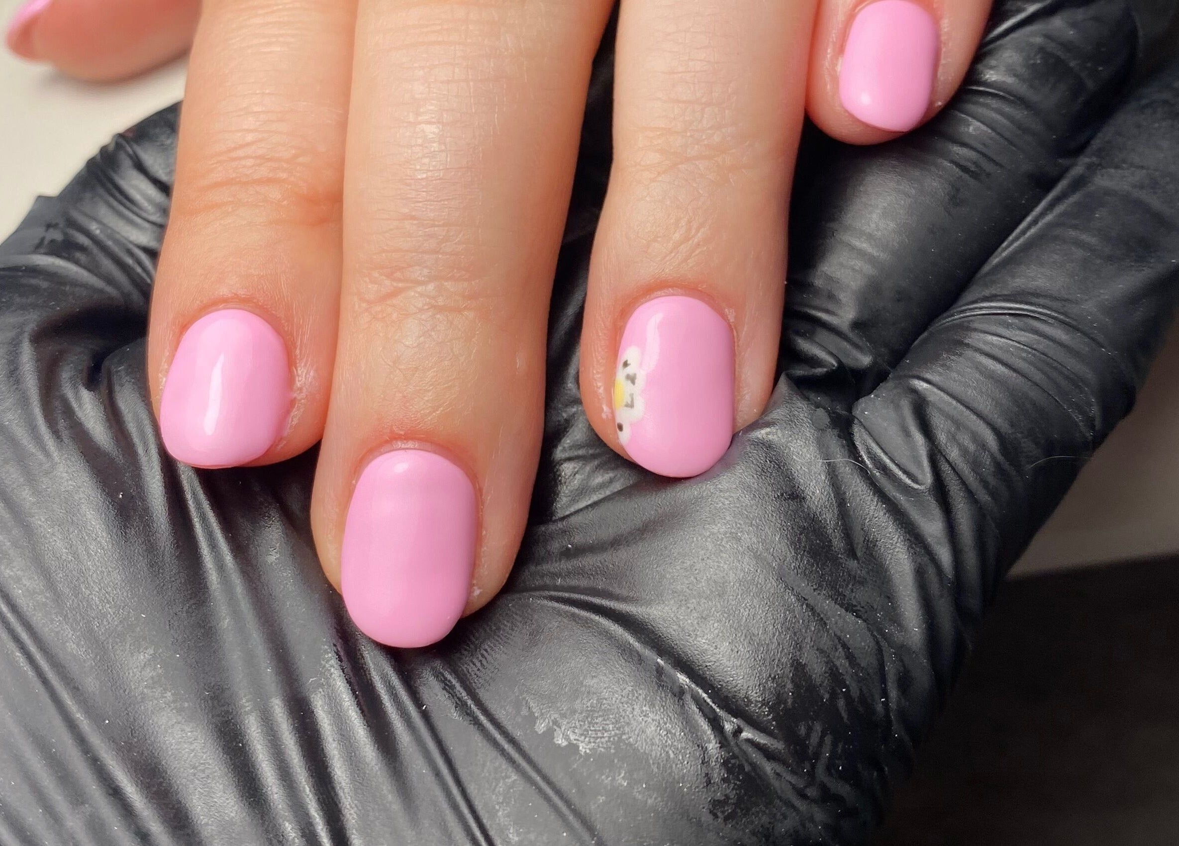 Beautiful pink gel manicure at JD Nails in Telford, England, GB, featuring elegant floral accent.