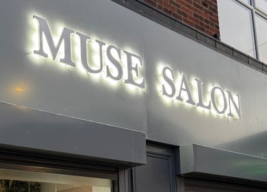 Brightly lit Muse Salon sign at By Kate Easton, Blyth, England, GB, showcasing elegance.