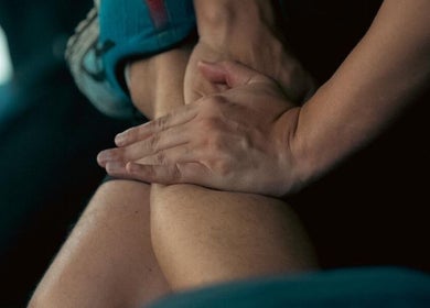 Hands providing a soothing leg massage at 1st Nations Polynesian Basketball (Pulman Arena), Takanini, Auckland, NZ.