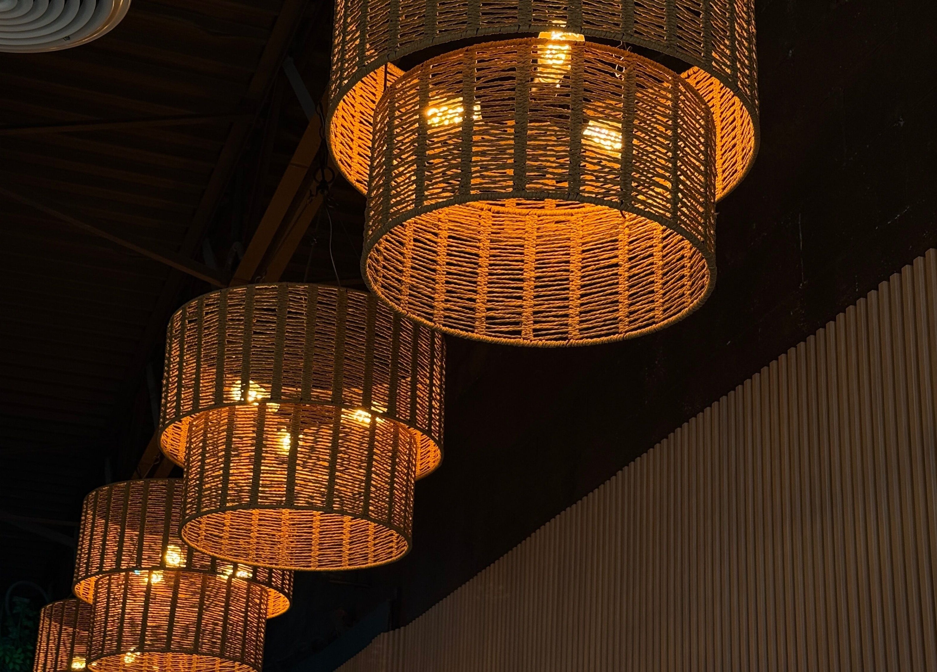Warm woven pendant lights at Chéri Nails and Spa, El Paso, Texas, US create a cozy ambiance.