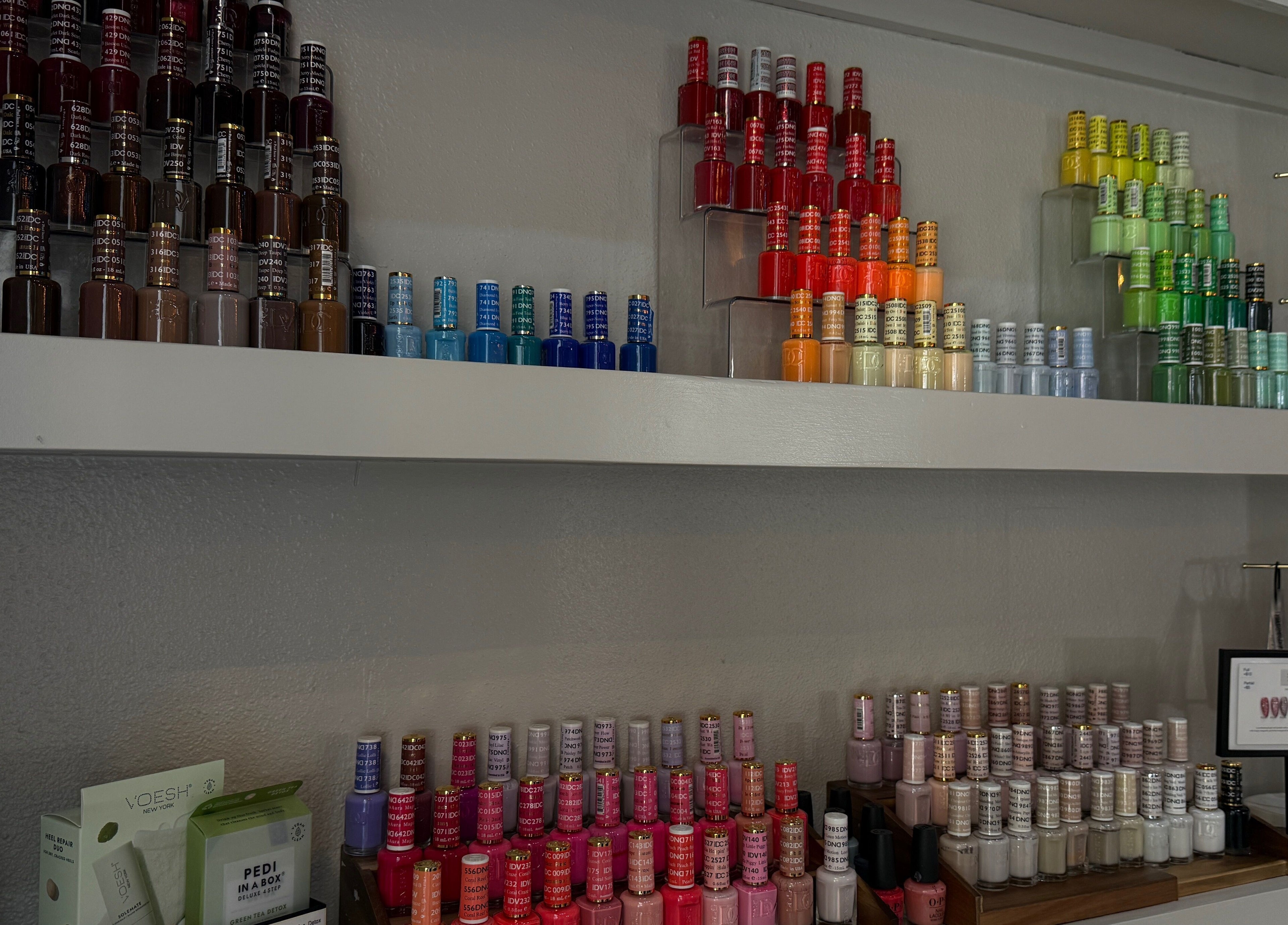Colorful nail polish display at Chéri Nails and Spa in El Paso, Texas, US, showcasing a wide shade range.