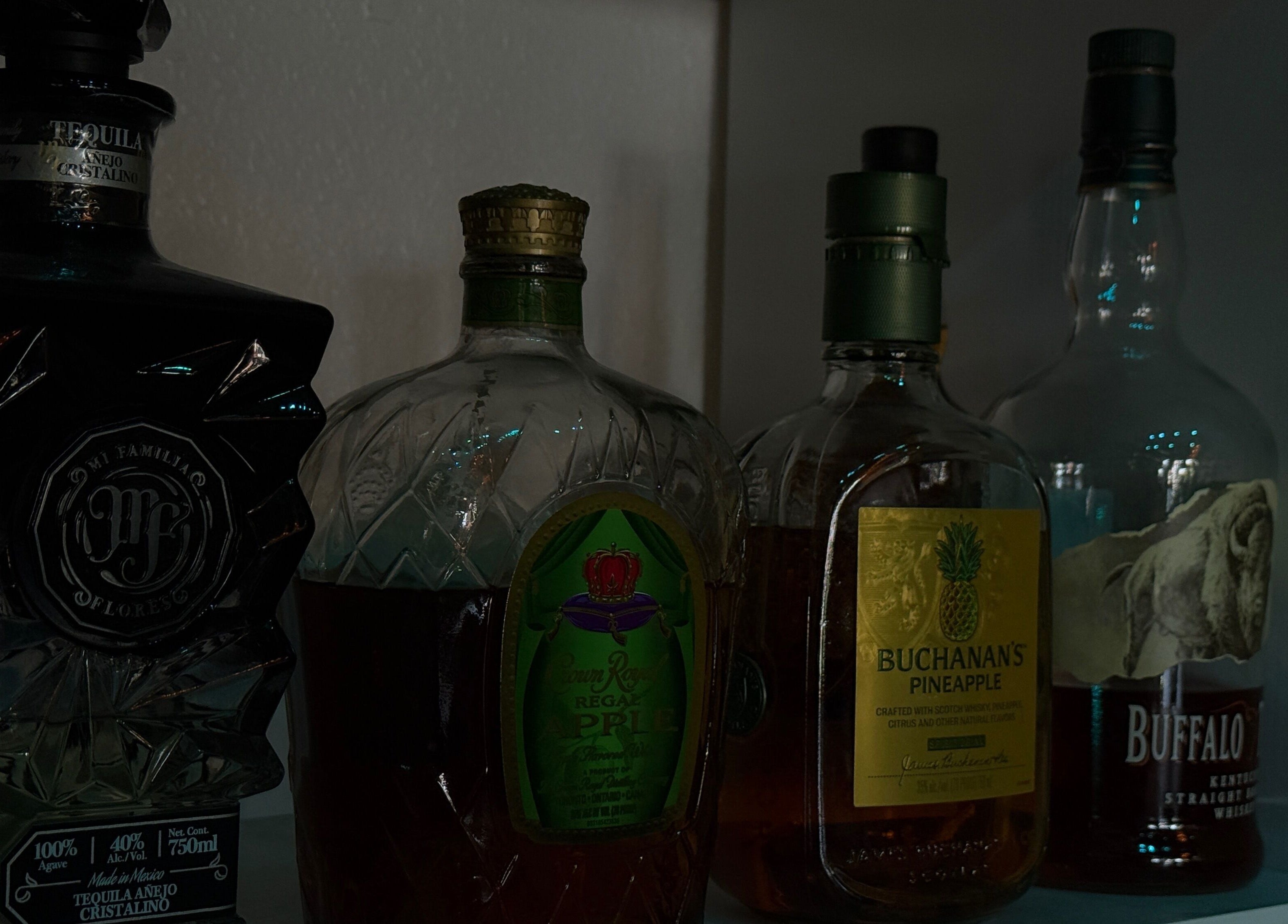 Chéri Nails and Spa in El Paso, Texas showcases a stylish liquor collection on display for guests.