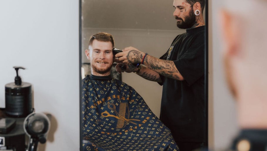 Barber working on a client's haircut at Anarchy Barber Shop in Logan Reserve, Queensland, AU.