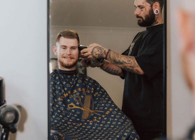 Barber working on a client's haircut at Anarchy Barber Shop in Logan Reserve, Queensland, AU.