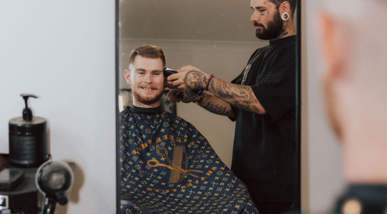 Barber working on a client's haircut at Anarchy Barber Shop in Logan Reserve, Queensland, AU.