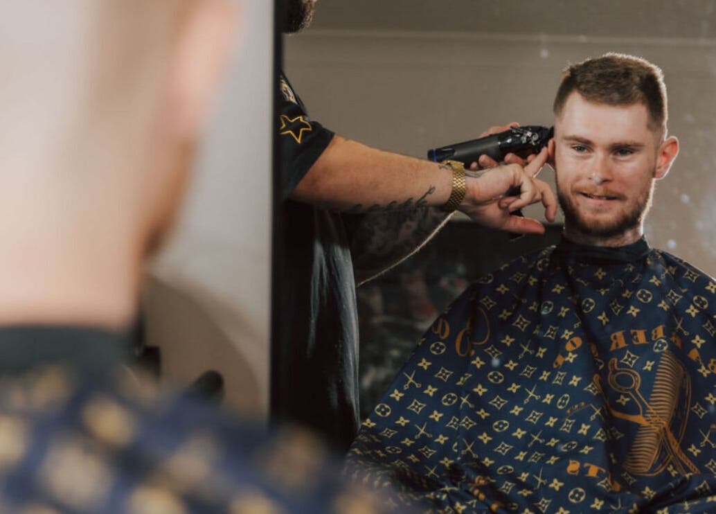 A client enjoys a haircut at Anarchy Barber Shop in Logan Reserve, Queensland, AU.