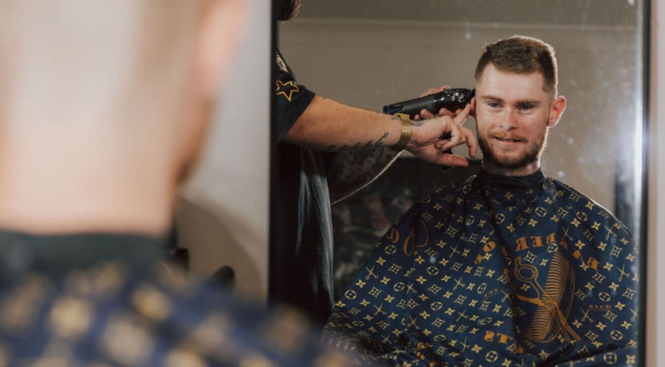 A client enjoys a haircut at Anarchy Barber Shop in Logan Reserve, Queensland, AU.