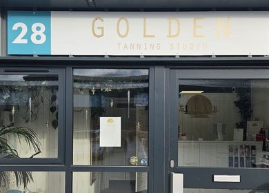 Entrance of Golden Tanning Studio in Wadebridge, England, GB showing modern facade and signage.