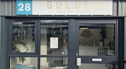 Front entrance of Golden Tanning Studio, Wadebridge, England, GB with inviting glass doors.