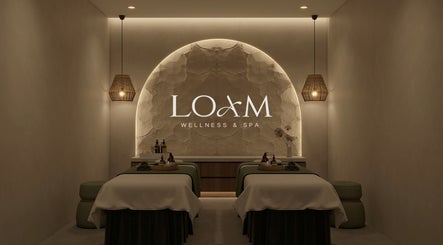 Relaxing treatment room at LOAM Wellness & Spa, Las Vegas, Nevada, US with massage tables and soft lighting.
