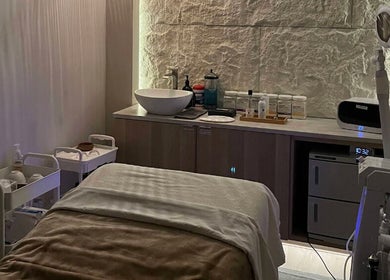 Tranquil treatment room at LOAM Wellness & Spa in Las Vegas, Nevada, US featuring massage bed and spa essentials.